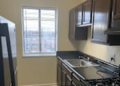 Thumbnail 16 of 19 - Modern, fully equipped kitchen at Meadowbrook Run Apartments with energy-efficient appliances, sleek cabinetry, and updated finishes in a bright, open-concept layout.