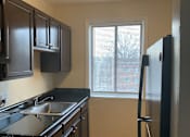 Thumbnail 15 of 19 - Modern, fully equipped kitchen at Meadowbrook Run Apartments with energy-efficient appliances, sleek cabinetry, and updated finishes in a bright, open-concept layout.