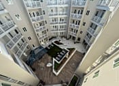 Thumbnail 7 of 10 - A top-down view of a courtyard surrounded by apartment buildings.
