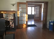 Thumbnail 3 of 6 - A room with a wooden ceiling and a window with blinds.