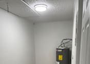 Thumbnail 10 of 28 - A small, white, enclosed space with a vent on the wall.