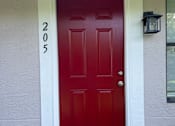 Thumbnail 28 of 28 - A red door with the number 205 on the bottom of it.