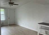 Thumbnail 6 of 28 - A ceiling fan hangs from the ceiling in a room with wooden walls.