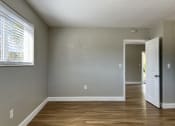 Thumbnail 11 of 12 - an empty room with a door and a window  at Palm Gardens @ Biscayne Gardens, Florida