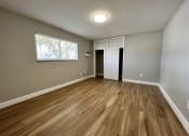 Thumbnail 4 of 12 - an empty living room with hardwood floors and a window  at Palm Gardens @ Biscayne Gardens, North Miami, FL