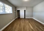 Thumbnail 8 of 12 - an empty living room with wooden floors and a window  at Palm Gardens @ Biscayne Gardens, North Miami, FL, 33181