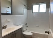 Thumbnail 5 of 12 - an empty bathroom with a sink toilet and tub  at Palm Gardens @ Biscayne Gardens, North Miami, FL