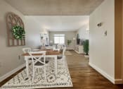 Thumbnail 7 of 14 - a living room and dining room with a table and chairs and a rug  at Palm Gardens @ Biscayne Gardens, North Miami, FL