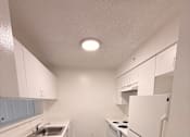 Thumbnail 16 of 28 - Empty Kitchen at Heron Pointe Apartments, Florida