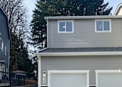 Thumbnail 4 of 48 - A house with a garage door opener attached to the wall.
