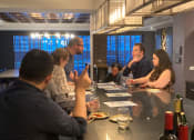 Thumbnail 6 of 7 - a group of people sitting around a table