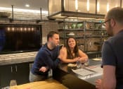 Thumbnail 2 of 7 - people sitting at a table in a restaurant