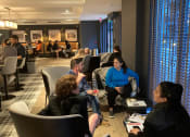 Thumbnail 4 of 7 - a group of people sitting in a room