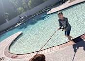 Thumbnail 62 of 62 - A man and his dog are enjoying a sunny day by the pool at Cliffs at Canyon Ridge, Ogden, Utah