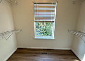Thumbnail 11 of 18 - A room with a window and a wooden door.
