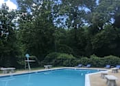 Thumbnail 26 of 29 - A pool with a diving board and a metal ladder. at New Carrollton Woods, Riverdale, MD