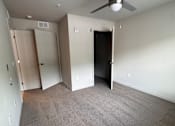 Thumbnail 5 of 9 - A white ceiling fan in a room with a built in cabinet.