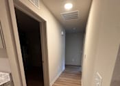 Thumbnail 3 of 9 - A room with a desk and a window with blinds.