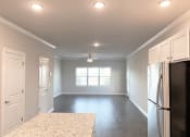 Thumbnail 18 of 60 - B2 (2-car) Downstairs open concept living and dining with laminate wood flooring
