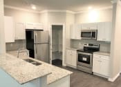 Thumbnail 35 of 60 - C1 (1-car) Kitchen with raised bar, granite coutnertops, stainless steel appliances