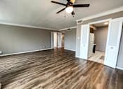 Thumbnail 5 of 28 - dining area looking into the kitchen and living room with a ceiling fan