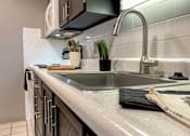 Thumbnail 2 of 28 - A kitchen with a sink and a countertop.