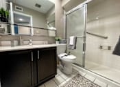 Thumbnail 8 of 28 - bathroom with black cabinet and shower