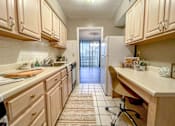 Thumbnail 11 of 28 - A kitchen with wood cabinets and a white refrigerator.