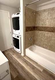 A bathroom with a white sink and a white bathtub.