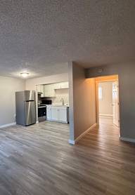A white door is open to a hallway.