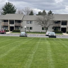 cars parked in front of an apartment building