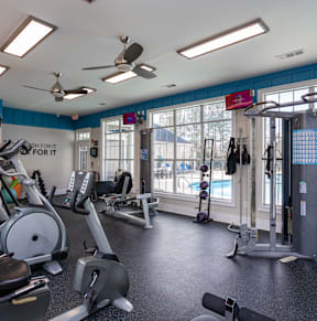 a gym with cardio equipment and weights