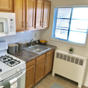 a kitchen with a stove microwave and sink