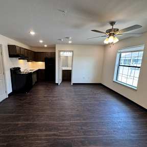 A room with a ceiling fan and a window.