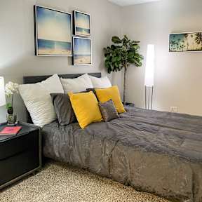 a bedroom with a bed and pictures on the wall