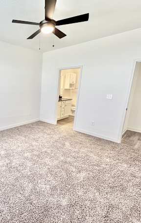 A room with a ceiling fan and carpeted floor.at Concord Crossing, Lafayette Indiana