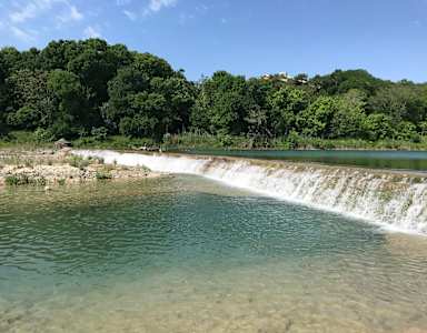 A small waterfall in a natural setting.