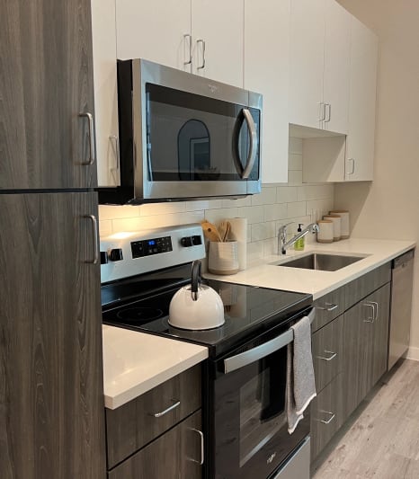 Stainless Steel Appliances, Two-Tone Cabinets in Kitchen with Subway Tile Backsplash in Austin, Texas