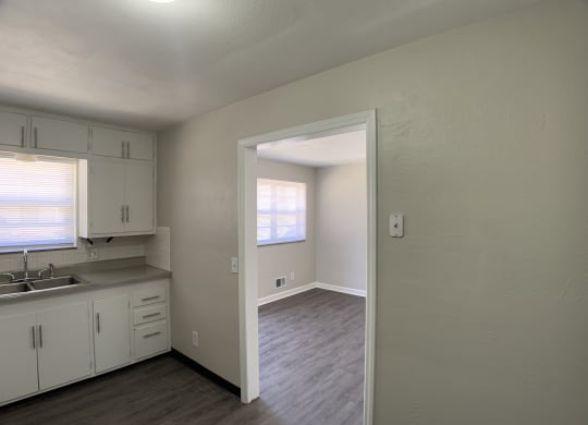 Spacious cabinetry in kitchen, looking into living room