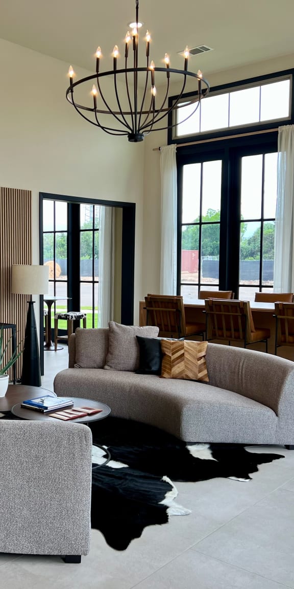 a living room with two couches a coffee table and a dining room table in the background