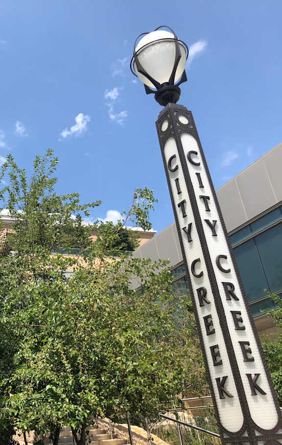 a sign for city creek conservancy in front of a building