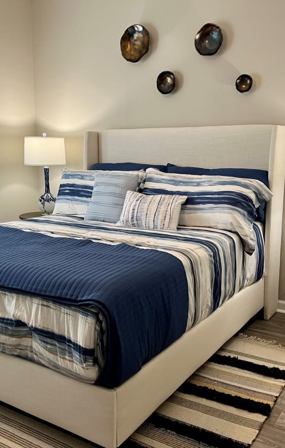 a bedroom with a bed and two lamps and a window at The Atlantic River West, Georgia, 30336