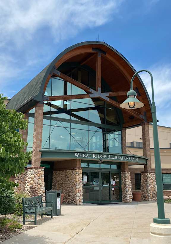 The front of a building with a sign that says "Wheat Ridge Recreation Center."