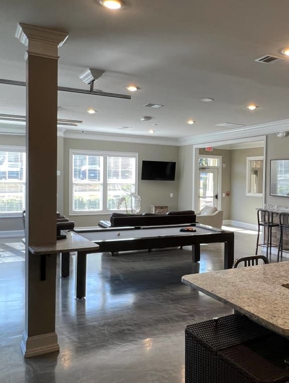 a large living room with leather couches and a coffee table