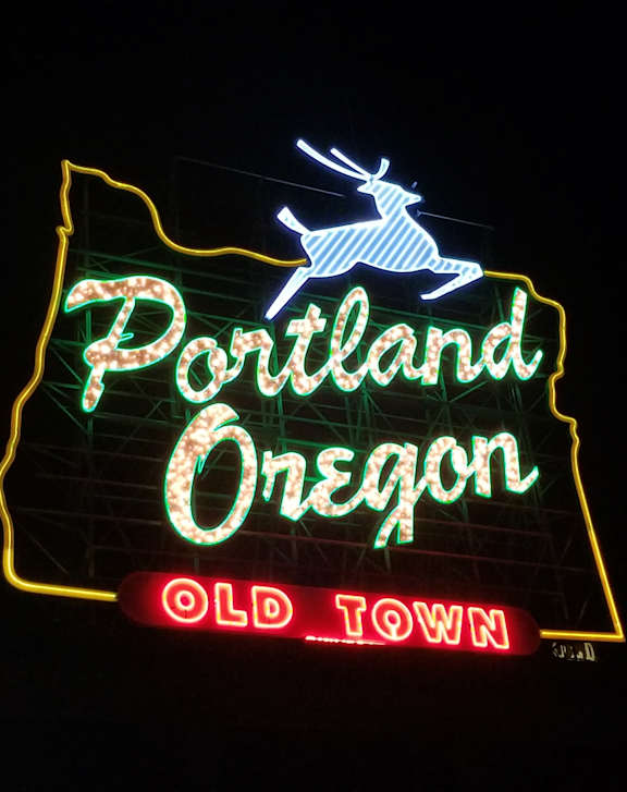 A neon sign in the shape of Oregon with the words at The Lafayette, Portland, OR, 97205