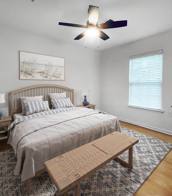 a bedroom with a bed and a ceiling fan