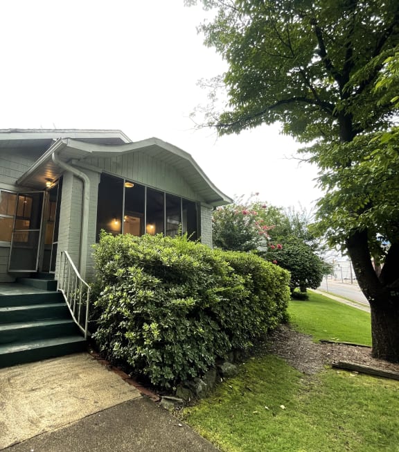 the front of a house with green steps