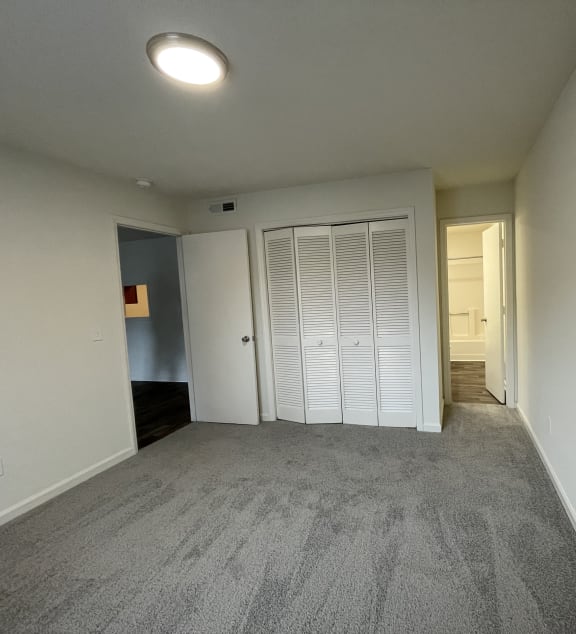 an empty room with a door and a window