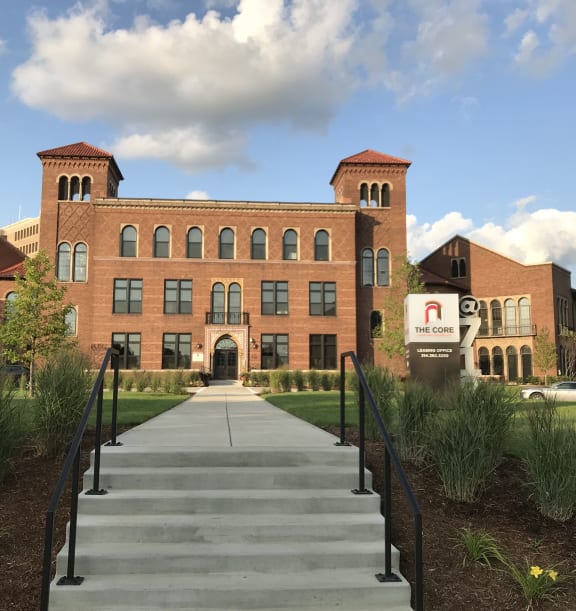 a large brick building with stairs in front of it