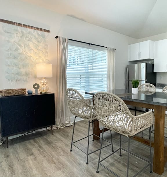 a covered patio with couches and chairs and a tv at Emery Village, Concord